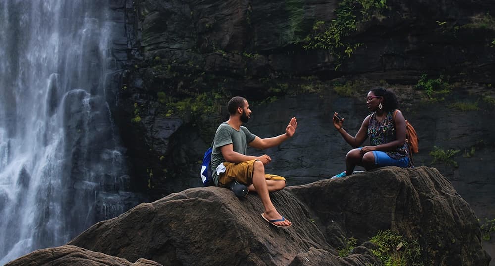 Friends chatting by waterfall