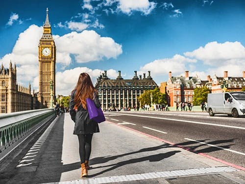 Woman walking on Westminster bridge in London.